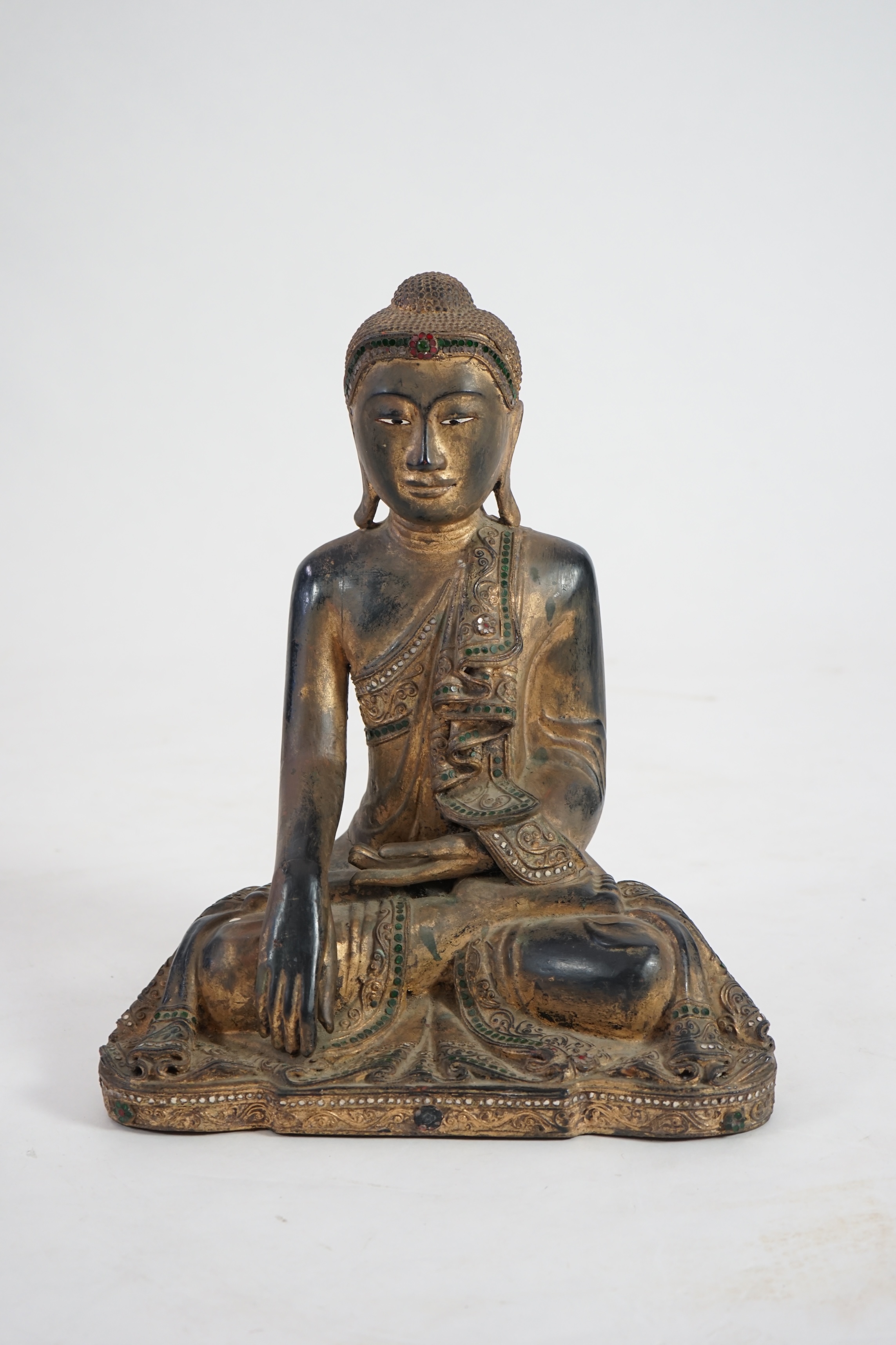 An Asian gem set lacquered and carved wood Buddha